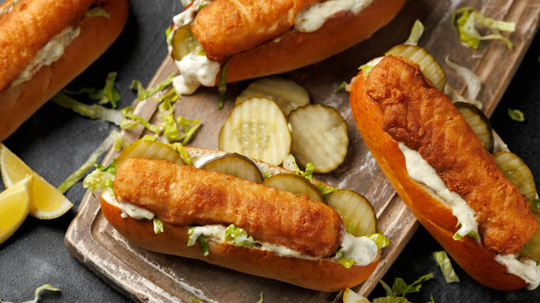Fish sticks in a hotdog bun with pickles