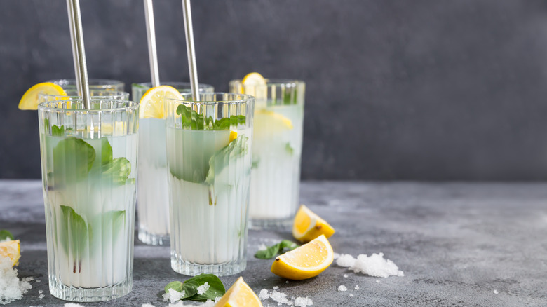 Several tall glasses of water with lemon