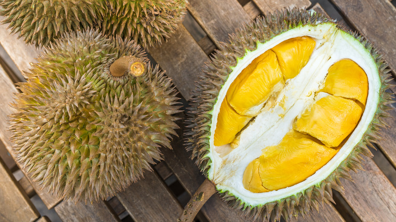 two durian fruits, one opened