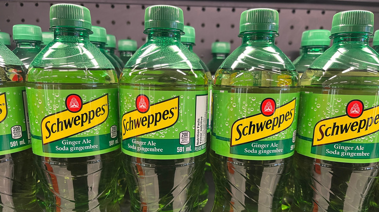 Bottles of Schweppes ginger ale on a shelf