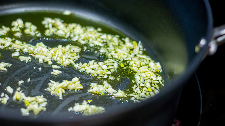 Finely chopped garlic cooking in a pan