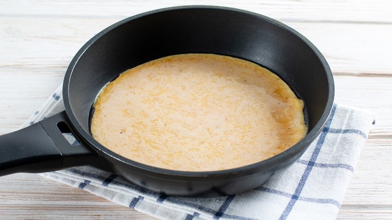 Eggs in skillet on table