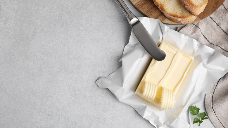 Butter knife next to a block of butter