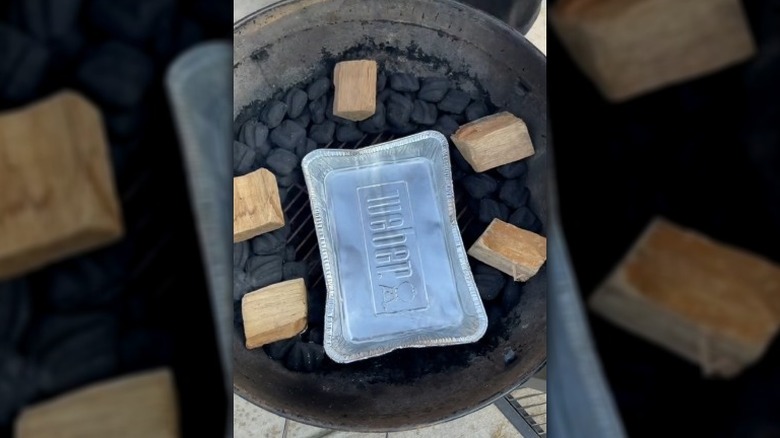 Smoking BBQ grill in backyard