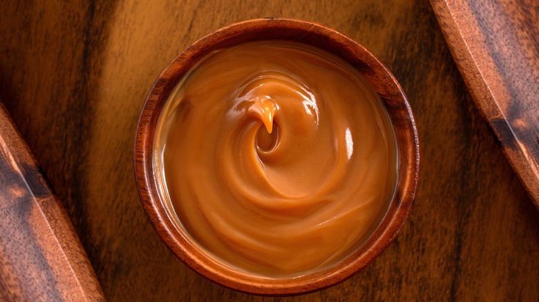 Dulce de leche in a wooden bowl