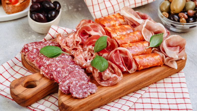 A charcuterie board with sliced cured meats