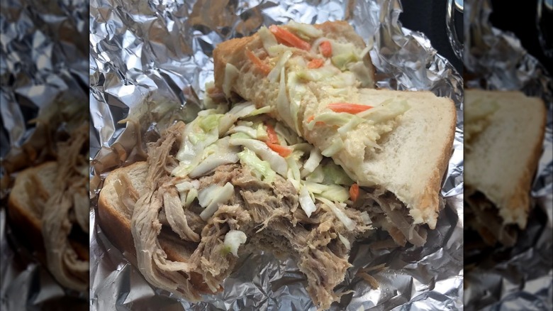 A pulled pork sandwich from Jones bar-B-Q Diner opened with coleslaw on aluminum foil