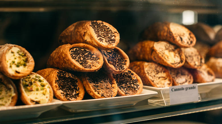 Cannoli behind a bakery counter