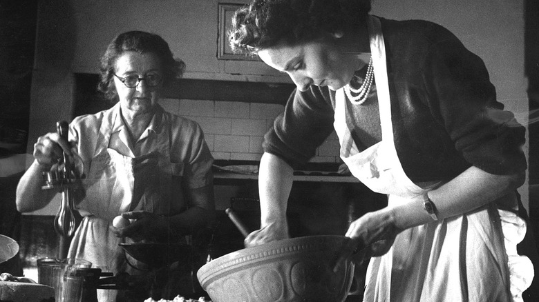 This vintage photo shows women cooking.