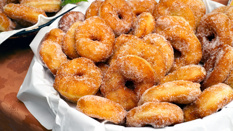 Bowl of small crispy fried sugared donuts