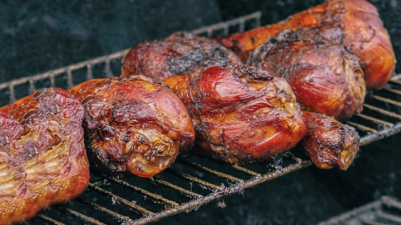 Turkey legs on a grill rack.