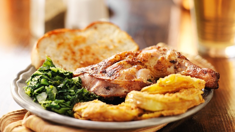 Soul food plate with greens, meat, and bread