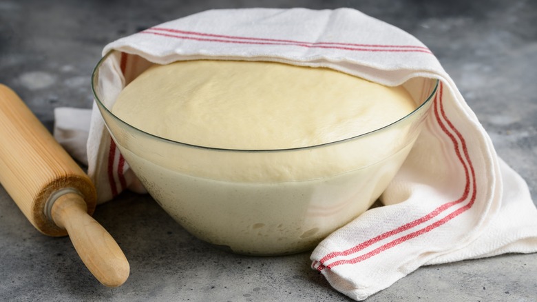 Dough rising in glass bowl