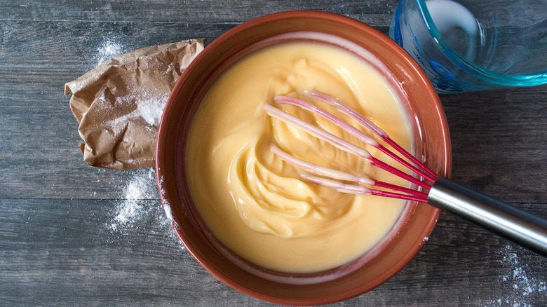 Bowl of pudding with whisk