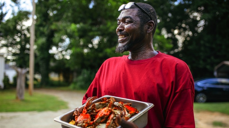 South Carolina man carrying bowl of crabs