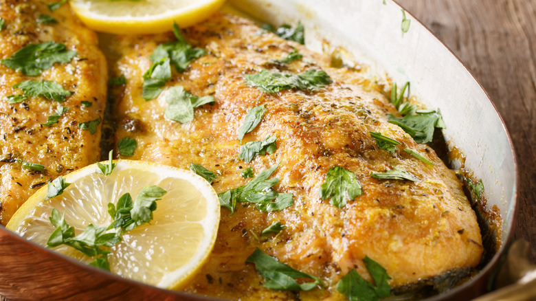 Fish in pan with butter and herbs