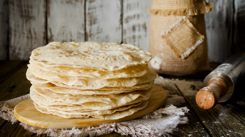 stack of tortillas on a cutting board