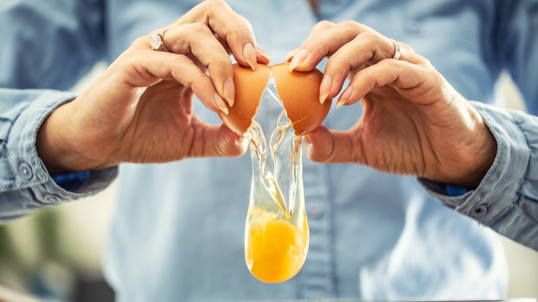 Hands cracking an egg close-up