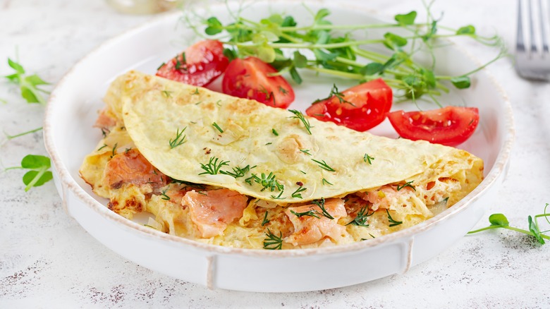 Breakfast taco on a plate with tomatoes