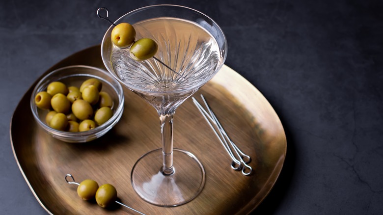 Dirty martini on tray with olives