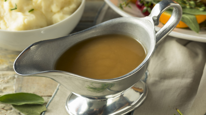 Silver gravy boat filled with brown gravy