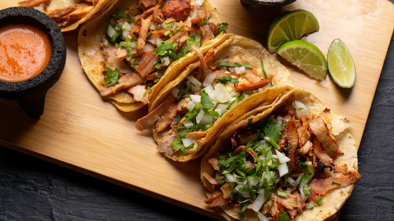 Al pastor tacos on cutting board