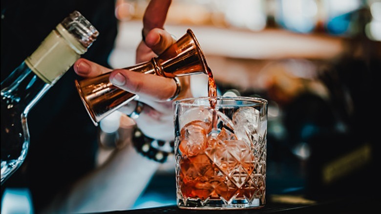 Bartender making negroni cocktail