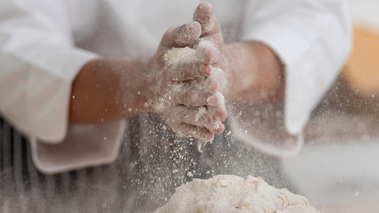 Chef using flour for baking