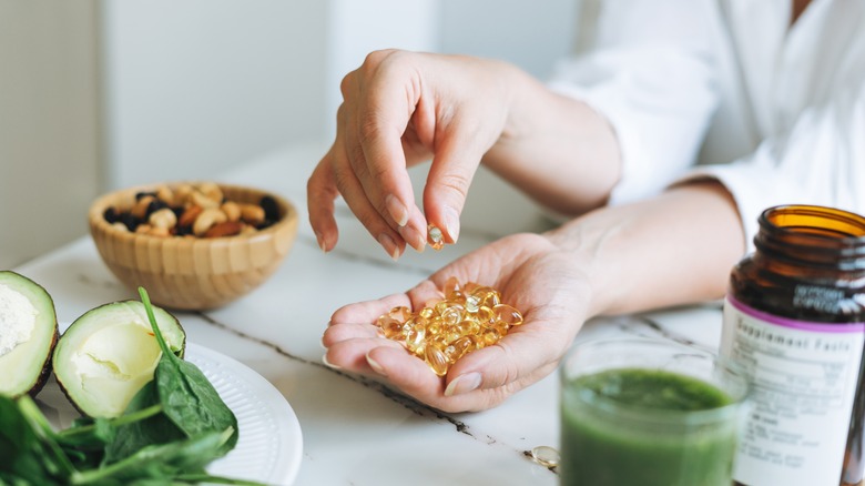 omega supplements in a woman's hand