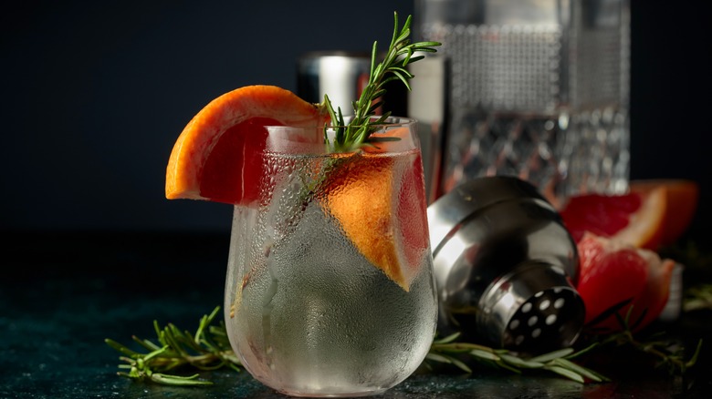 Chilled cocktail with rosemary sprig and citrus slices