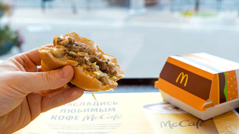 Person holding McDonald's burger in hands