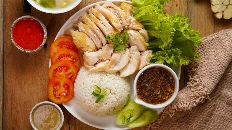 poached chicken in a salad with rice and toppings