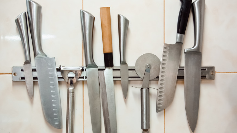 Knives attached to a wall holder