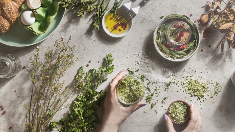 Hands working with dried herbs