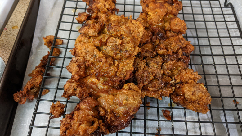 Fried chicken resting on a wire rack