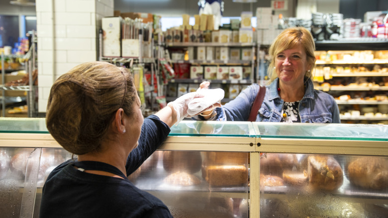 Person receiving deli order at counter