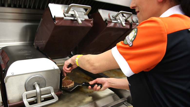 mcdonald worker making a burger