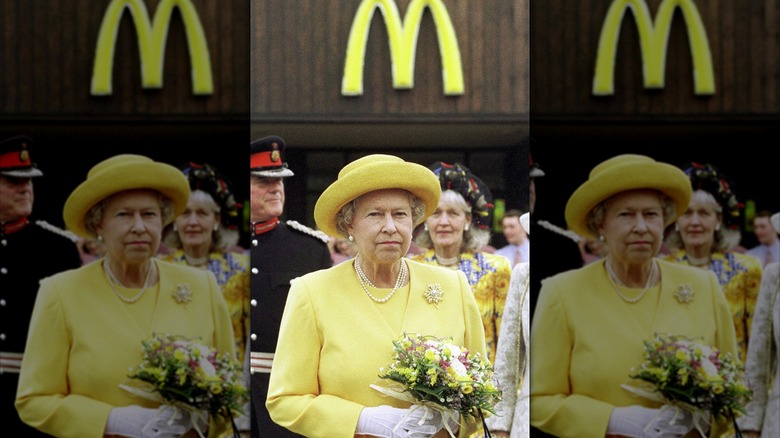 Queen Elizabeth wearing yellow outside of a McDonald's restaurant