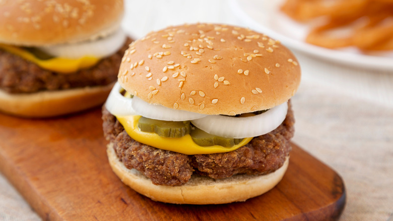 Slugburger with pickles and onions on a cutting board