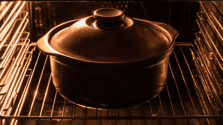 A cast iron pot preheating in an oven