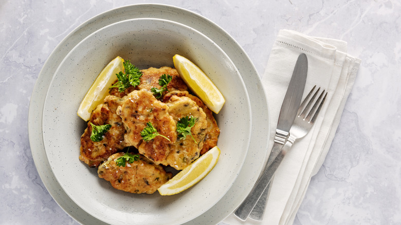 Salmon cakes in bowl with lemon