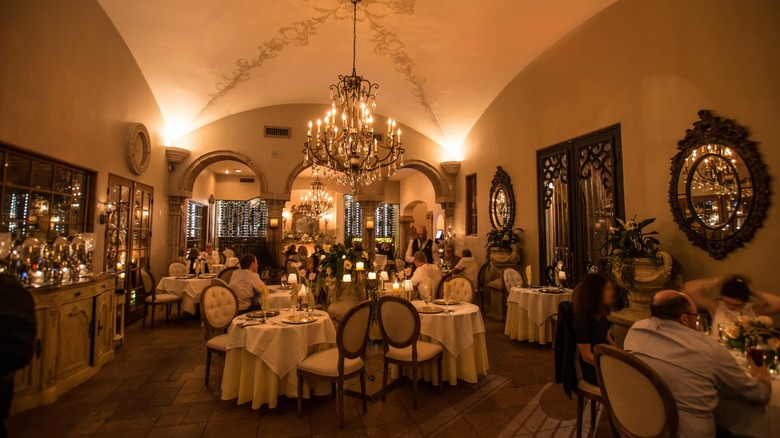 A dining room with chandeliers and fancy decor