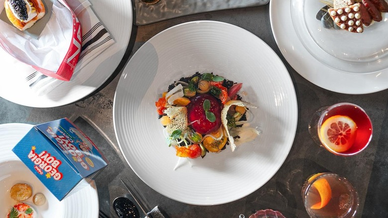 A number of fancy dishes on white plates