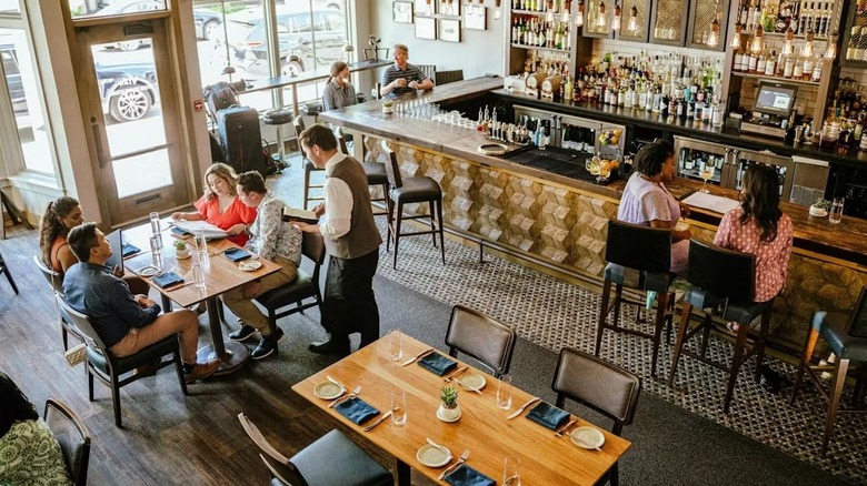A light-filled dining room filled with people