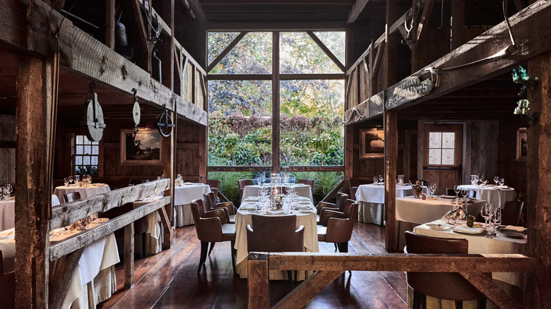 A rustic barn-like dining room with a large window