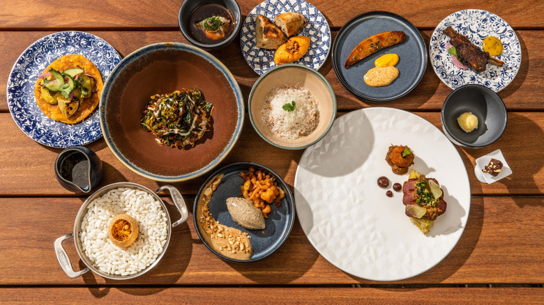 A bunch of different dishes spread on a table