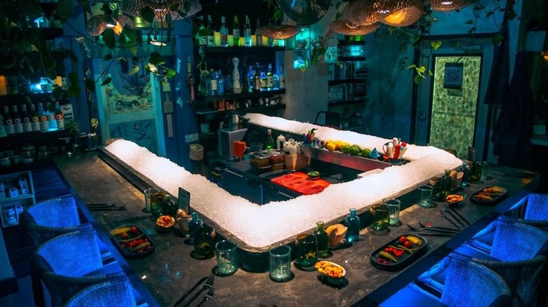 A U-shaped dining counter with a ring of ice