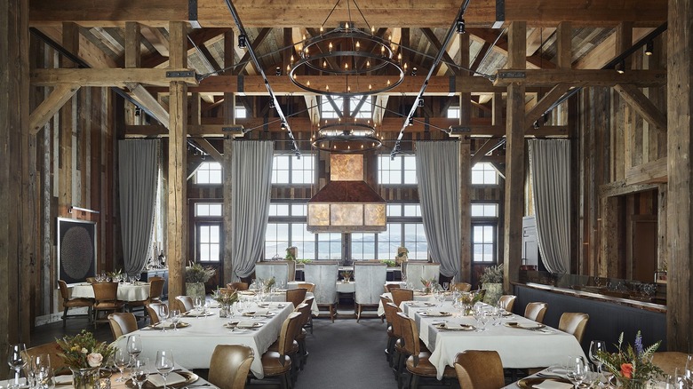 A giant dining room with landscape views and wood beams
