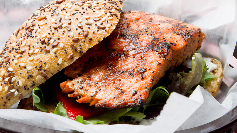 Grilled salmon on poppyseed and sesame bun