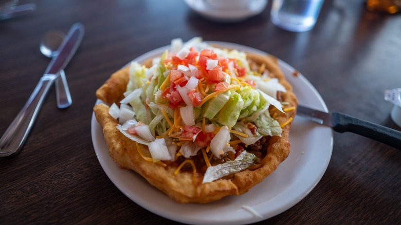 Navajo taco on plate on table in diner